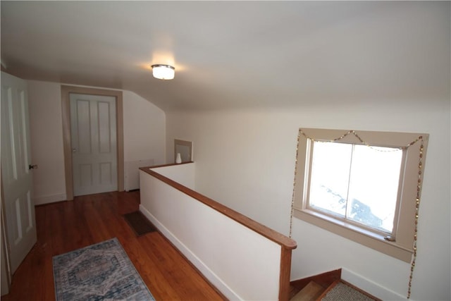 hall featuring visible vents, wood finished floors, an upstairs landing, and baseboards