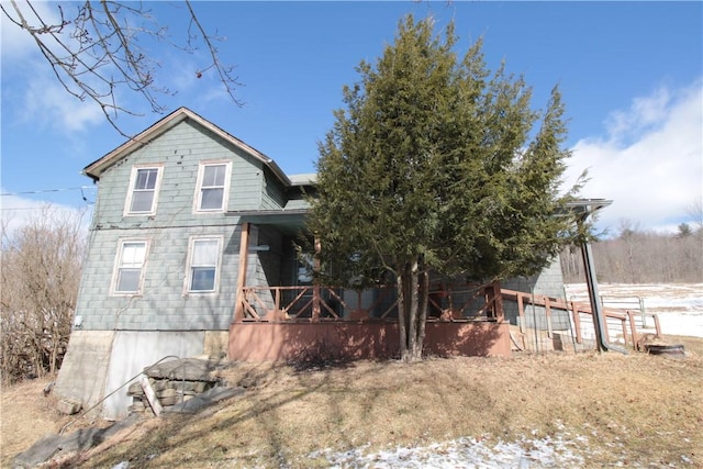 back of house featuring covered porch