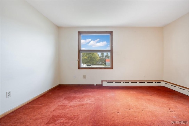 carpeted spare room featuring baseboards