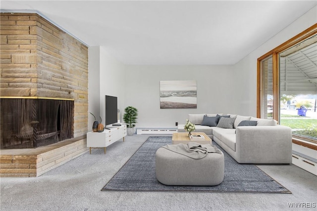 carpeted living area featuring a baseboard heating unit and a fireplace