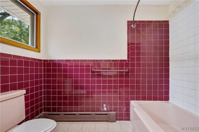 full bathroom with toilet, tile walls, baseboard heating, and walk in shower