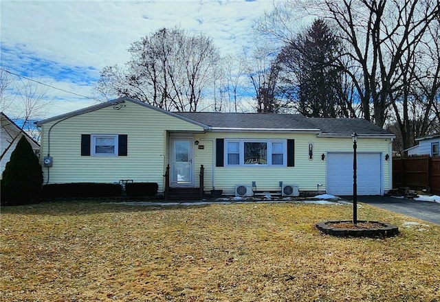 single story home with an attached garage, a front lawn, aphalt driveway, and entry steps