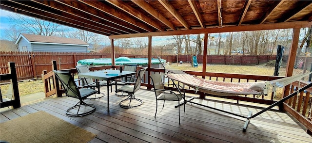 deck featuring a fenced backyard and outdoor dining area