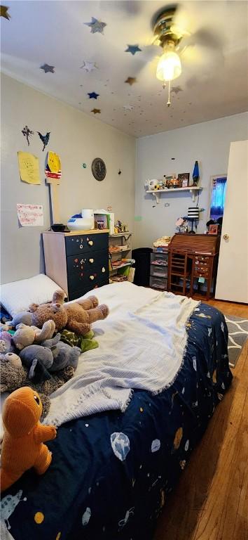 bedroom featuring lofted ceiling, ceiling fan, and wood finished floors