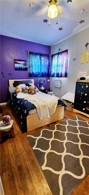 bedroom with a ceiling fan and hardwood / wood-style floors