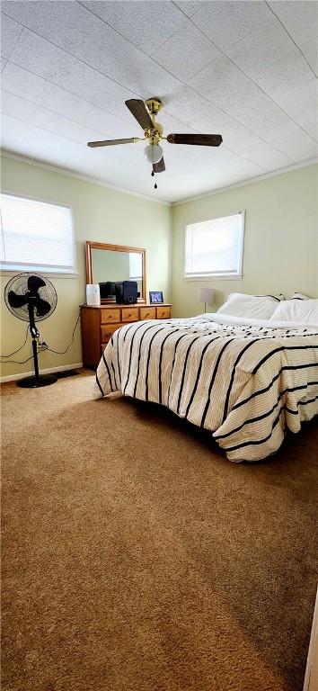 bedroom featuring carpet floors, multiple windows, and a ceiling fan