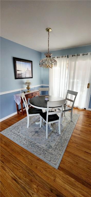 dining room featuring wood finished floors and baseboards