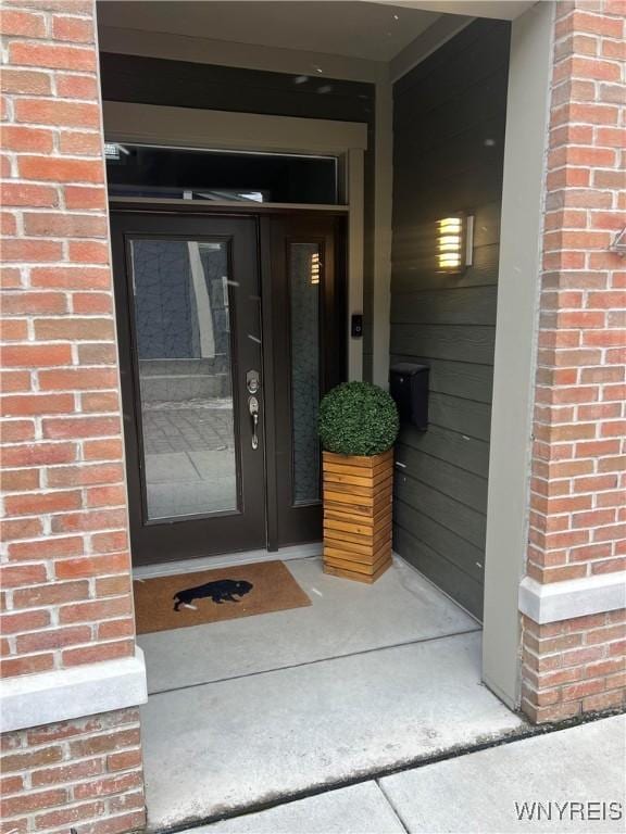 entrance to property with brick siding