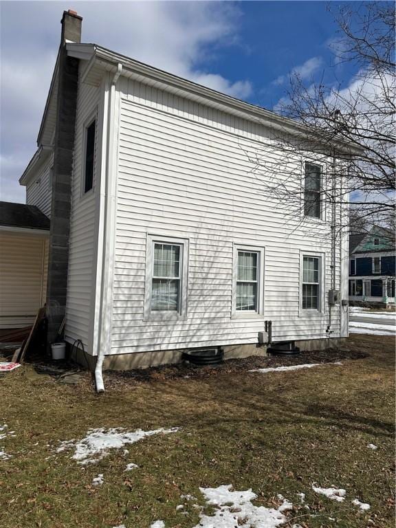 back of property with a chimney