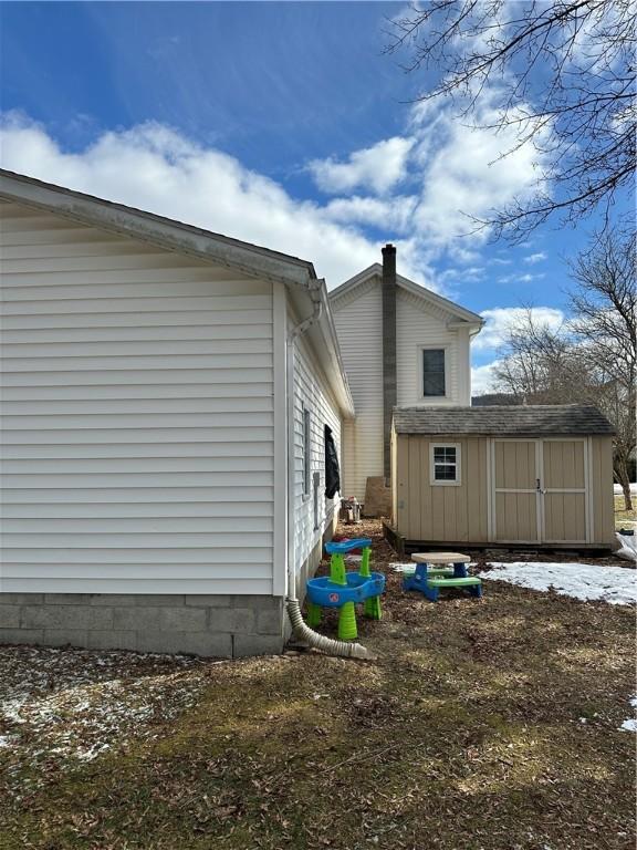 view of home's exterior featuring a storage shed and an outbuilding