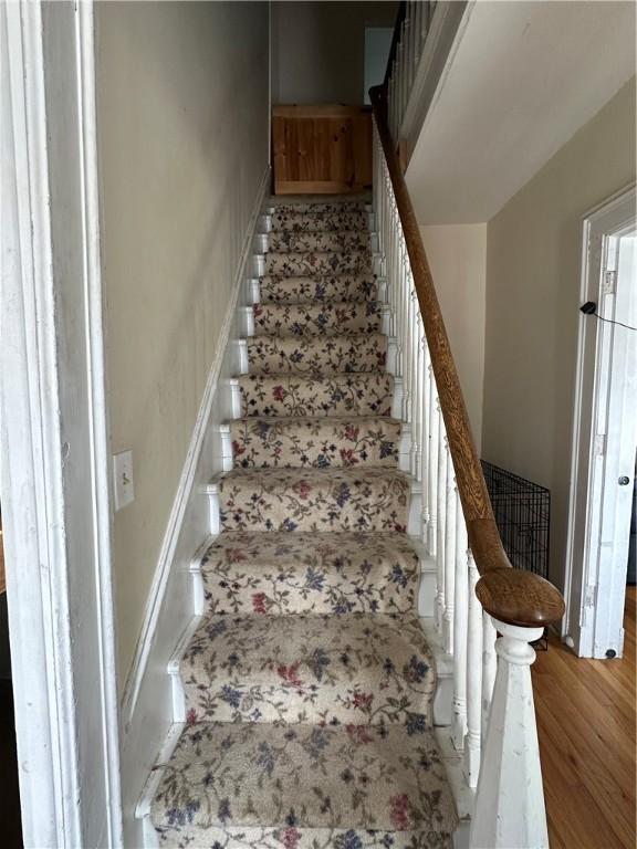 stairs featuring baseboards and wood finished floors