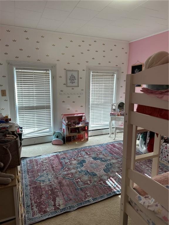 bedroom featuring wallpapered walls and carpet flooring