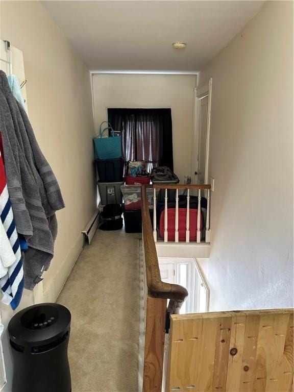 hallway featuring a baseboard heating unit and carpet floors