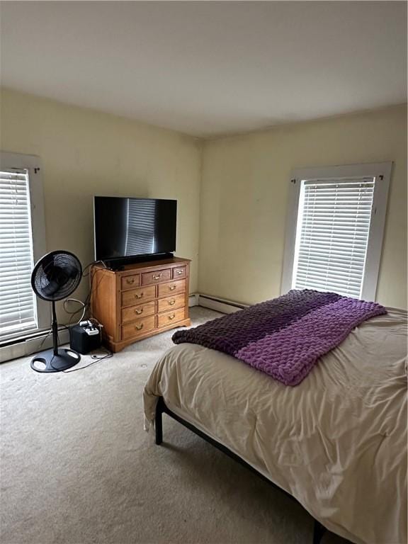 bedroom featuring a baseboard heating unit and carpet flooring