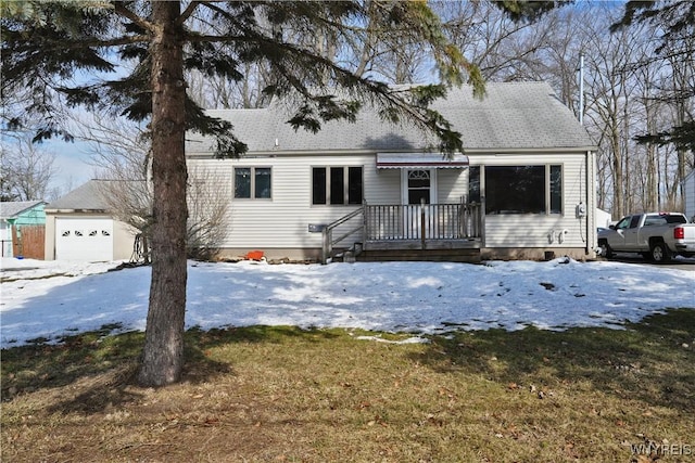 cape cod home with a garage and roof with shingles