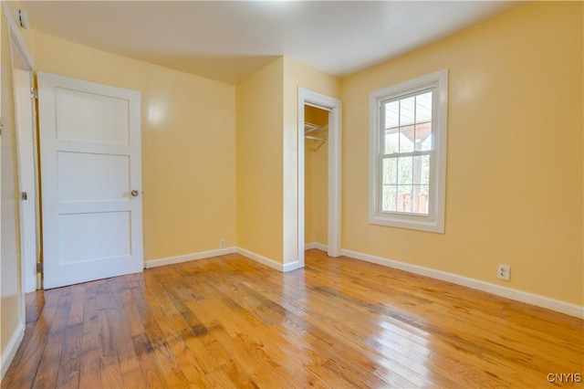 unfurnished bedroom with light wood-type flooring and baseboards