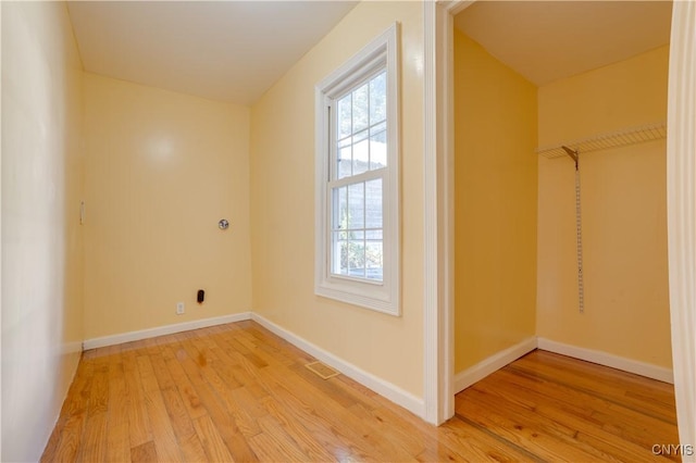 interior space with light wood-type flooring, plenty of natural light, and baseboards