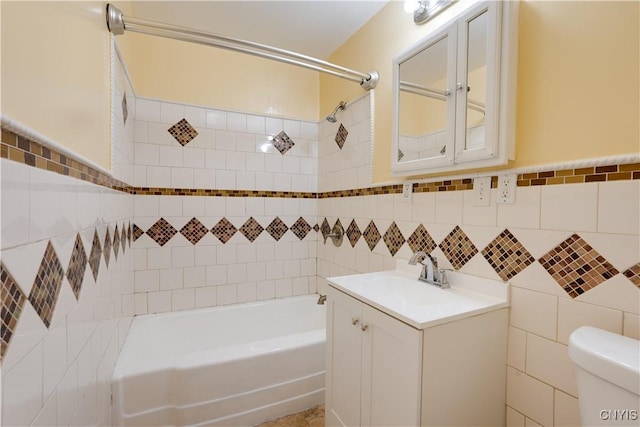 bathroom featuring tile walls, shower / bathing tub combination, vanity, and toilet