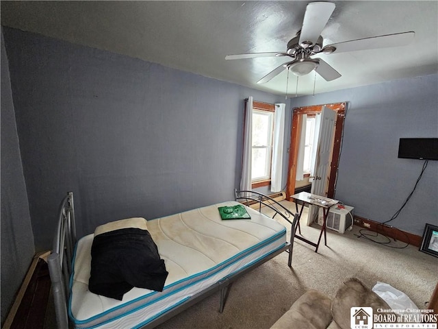 carpeted bedroom with baseboards and a ceiling fan