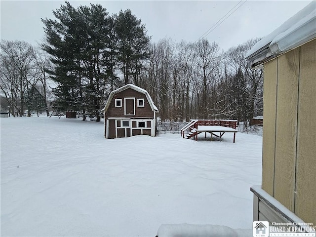 snowy yard featuring an outdoor structure