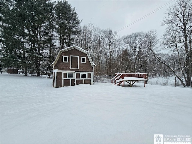 exterior space featuring an outbuilding and a gambrel roof