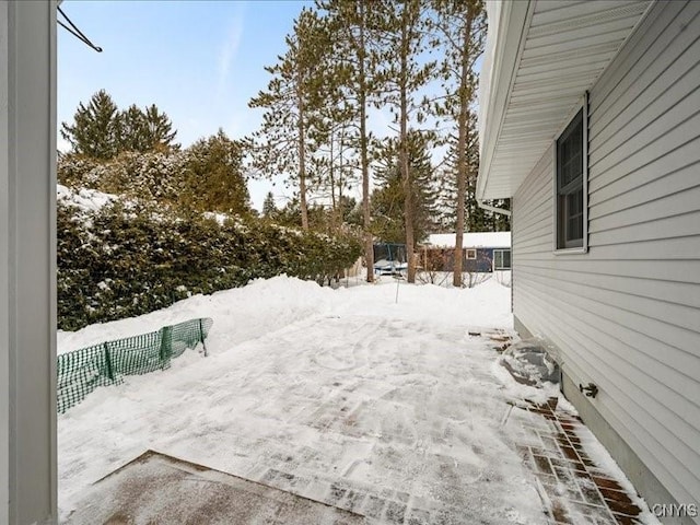 yard layered in snow with fence