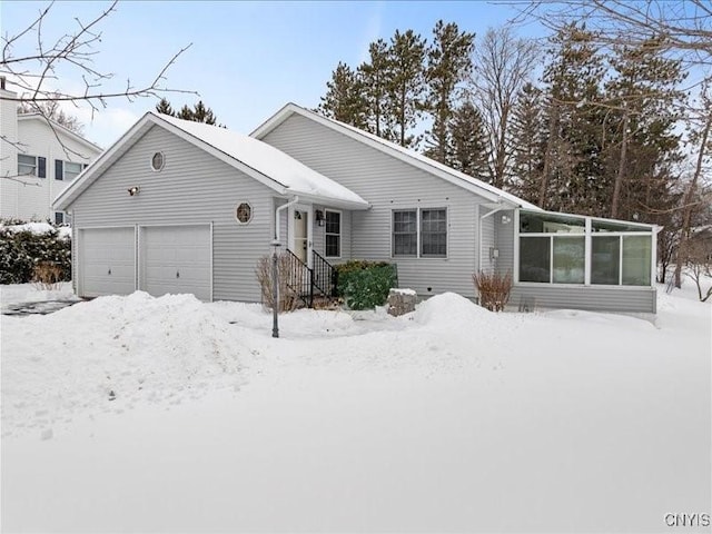 view of front of home featuring a garage and a sunroom