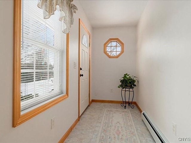 doorway with a baseboard heating unit and baseboards