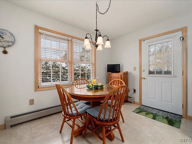 dining space with baseboards, baseboard heating, and a chandelier