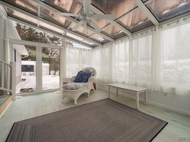 unfurnished sunroom with ceiling fan and lofted ceiling