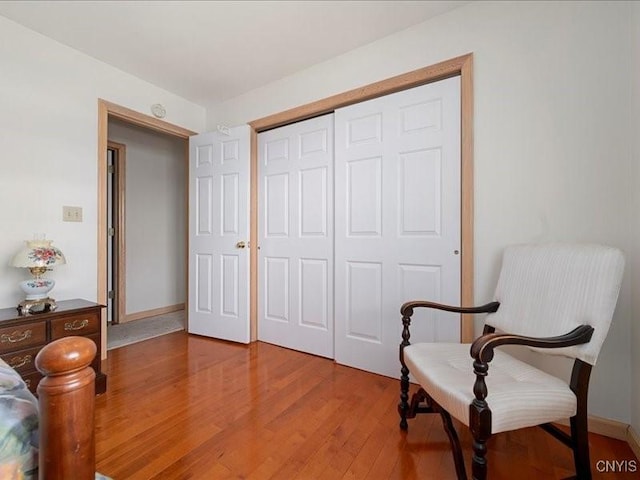 sitting room with light wood-type flooring and baseboards