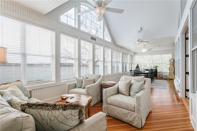 sunroom featuring lofted ceiling and ceiling fan