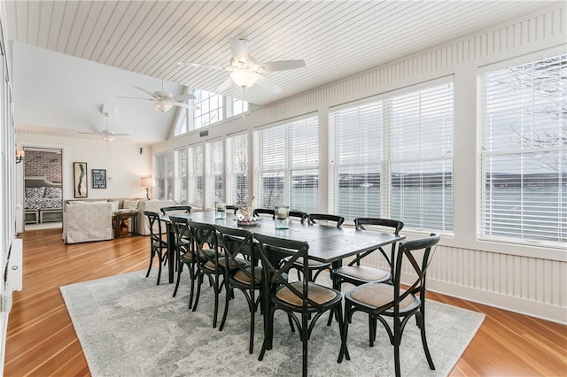 dining room with lofted ceiling and light wood-style floors