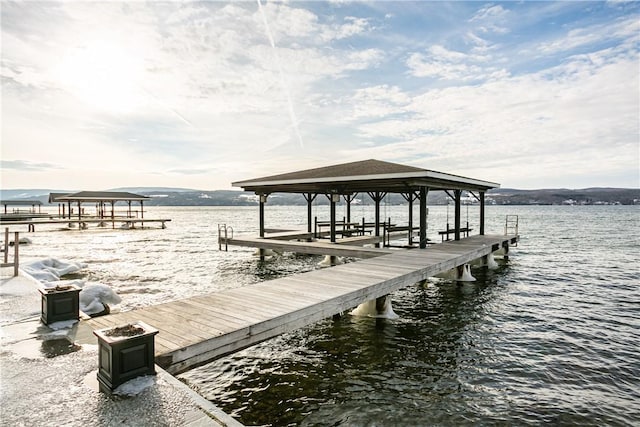 dock area with a water view and boat lift