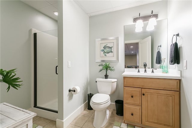 bathroom featuring toilet, a shower stall, vanity, tile patterned flooring, and baseboards