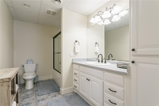 full bath featuring toilet, shower / bath combination with glass door, vanity, and visible vents