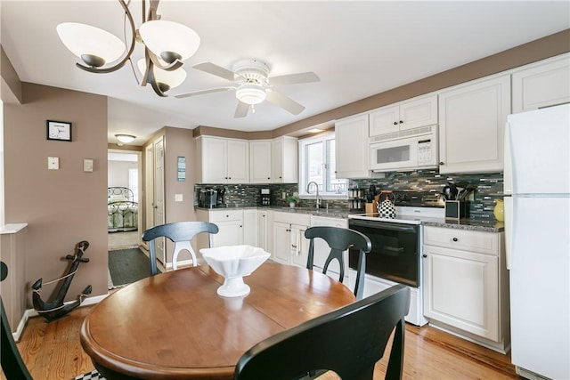 dining room with light wood-style flooring and a ceiling fan