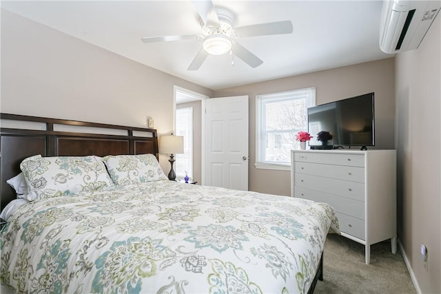 carpeted bedroom with ceiling fan, baseboards, and a wall mounted AC