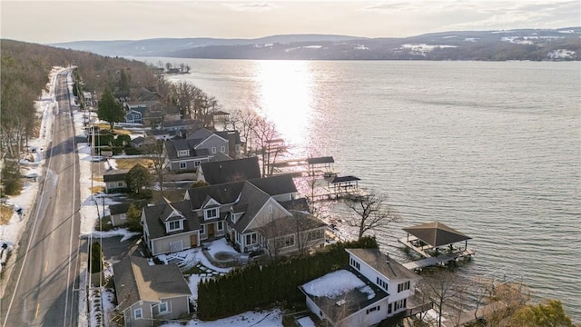 drone / aerial view featuring a water and mountain view