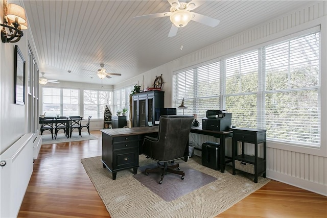 office space featuring radiator, plenty of natural light, and wood finished floors