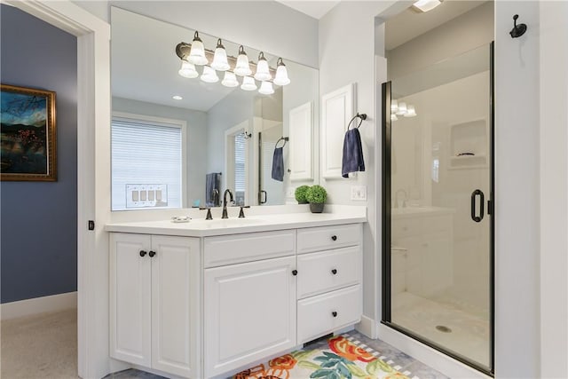 full bath with a shower stall, vanity, and baseboards