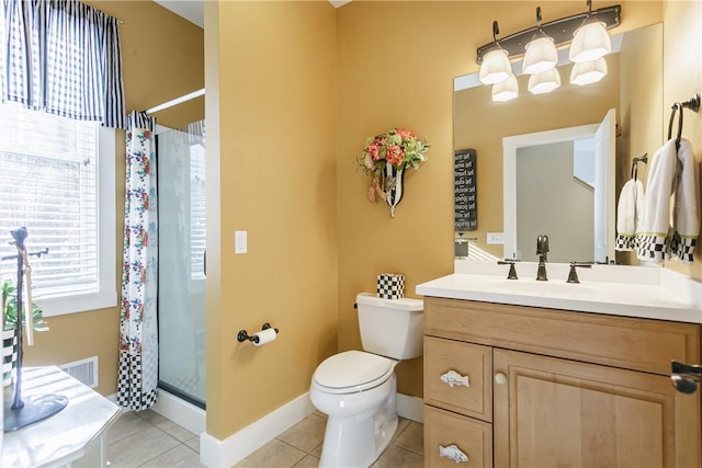 full bathroom featuring toilet, vanity, visible vents, a shower stall, and tile patterned floors