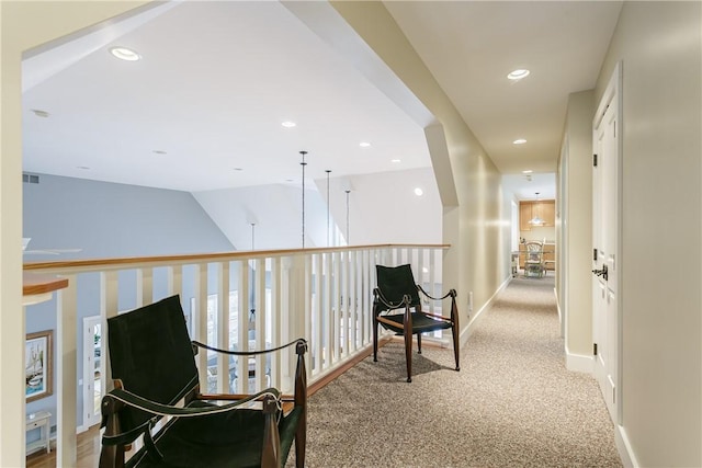 hall featuring carpet, visible vents, baseboards, and recessed lighting