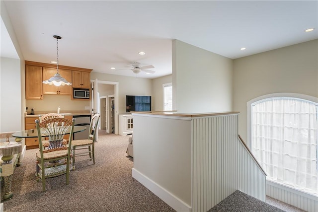 hall featuring an upstairs landing, recessed lighting, and carpet