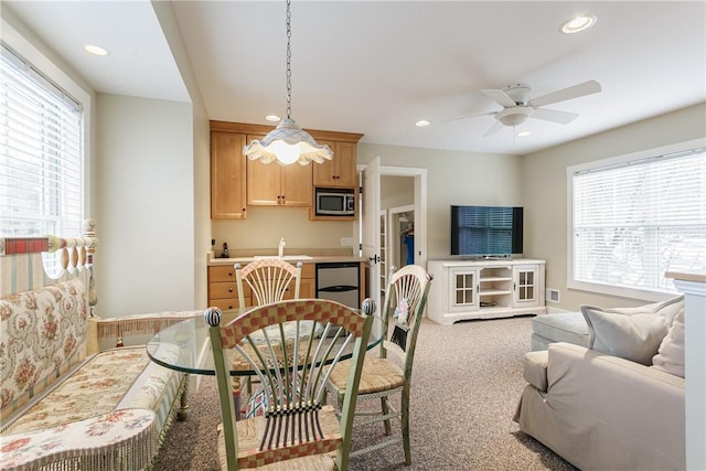 dining area featuring a healthy amount of sunlight, a ceiling fan, carpet flooring, and recessed lighting