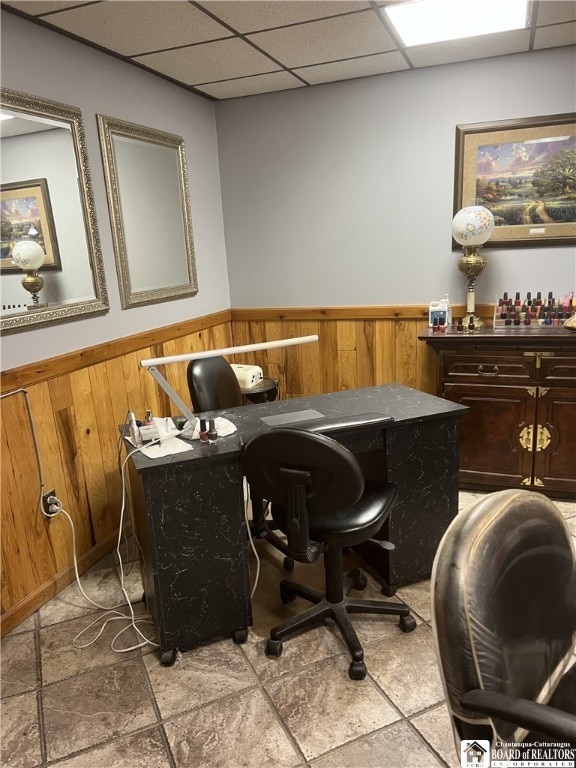 office with a paneled ceiling, wainscoting, and wood walls