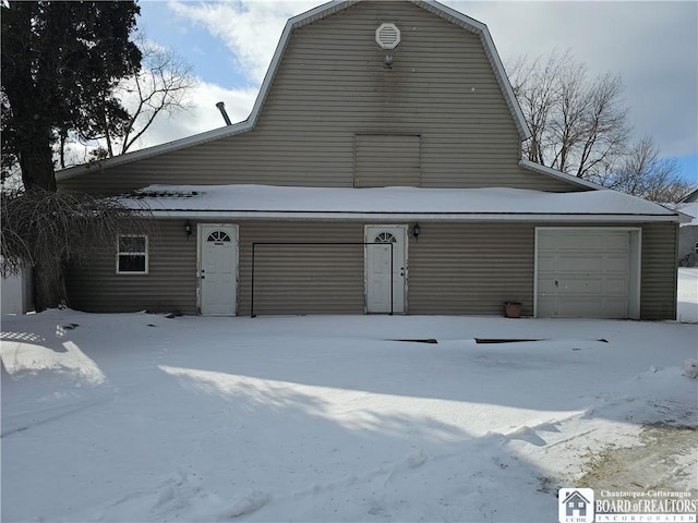 view of front of property with an attached garage and a gambrel roof