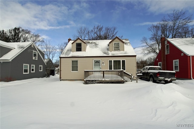 cape cod house with a deck and a chimney