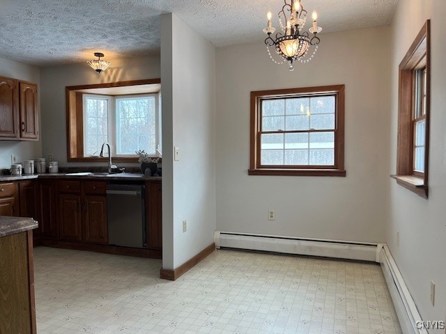 kitchen with a baseboard radiator, a baseboard heating unit, a wealth of natural light, dishwasher, and light floors