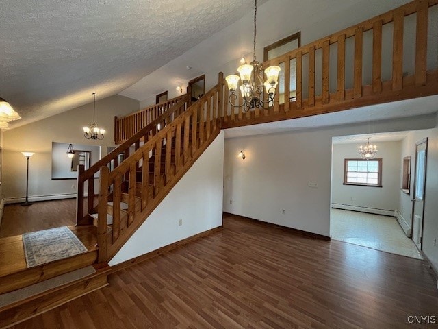 unfurnished living room with a chandelier, wood finished floors, and stairs